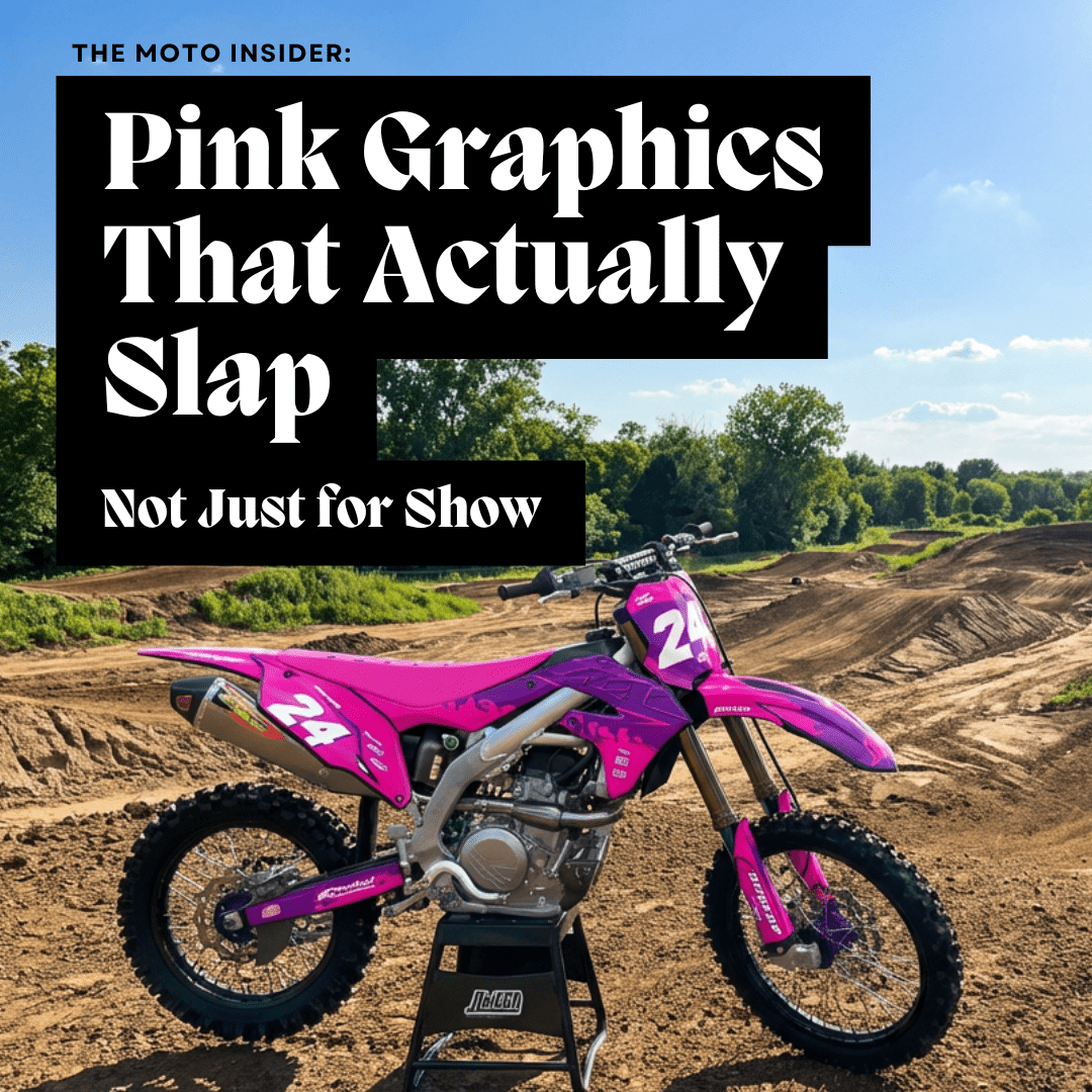 Pink and purple dirt bike with Pink Fire Omega moto graphics on a motocross track with dirt jumps and trees in the background