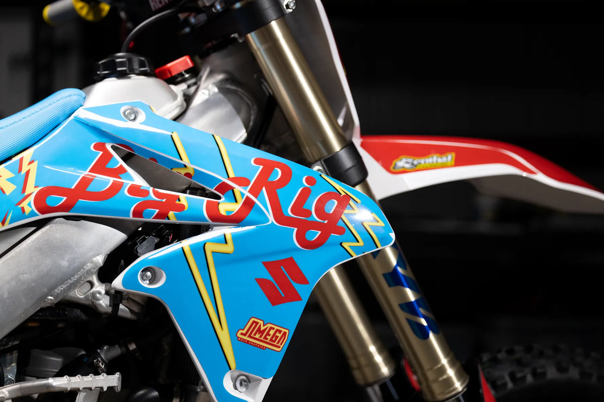 Close-up of blue and red custom graphics fitted across motorcycle plastics.