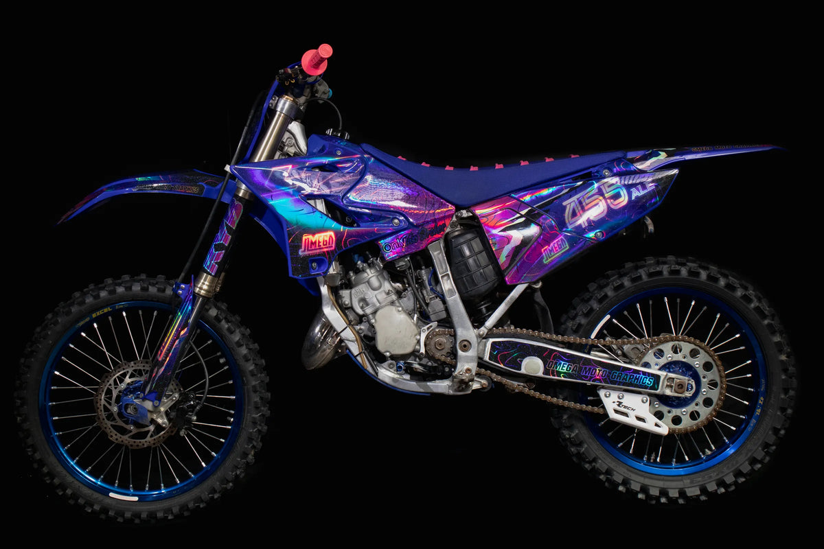 Motocross bike with custom Omega graphics, shown in full side profile
