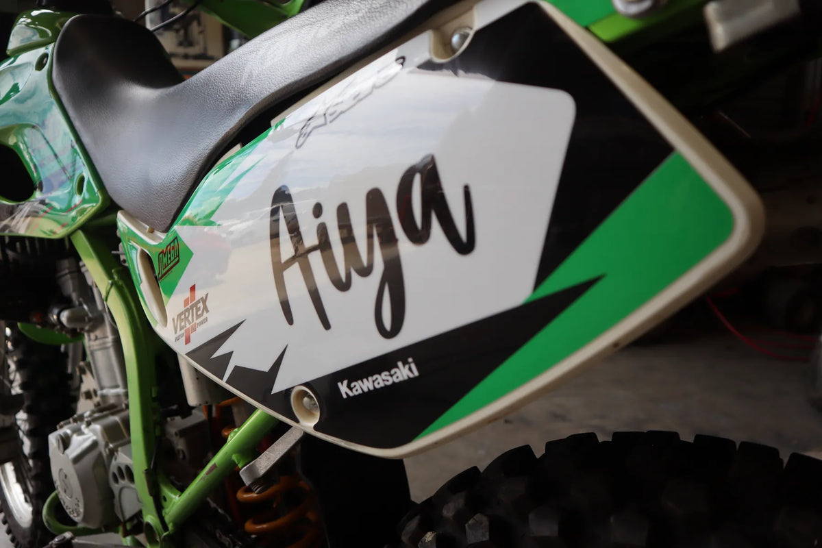 Close-up of the Aiya name on the green Kawasaki side panel.