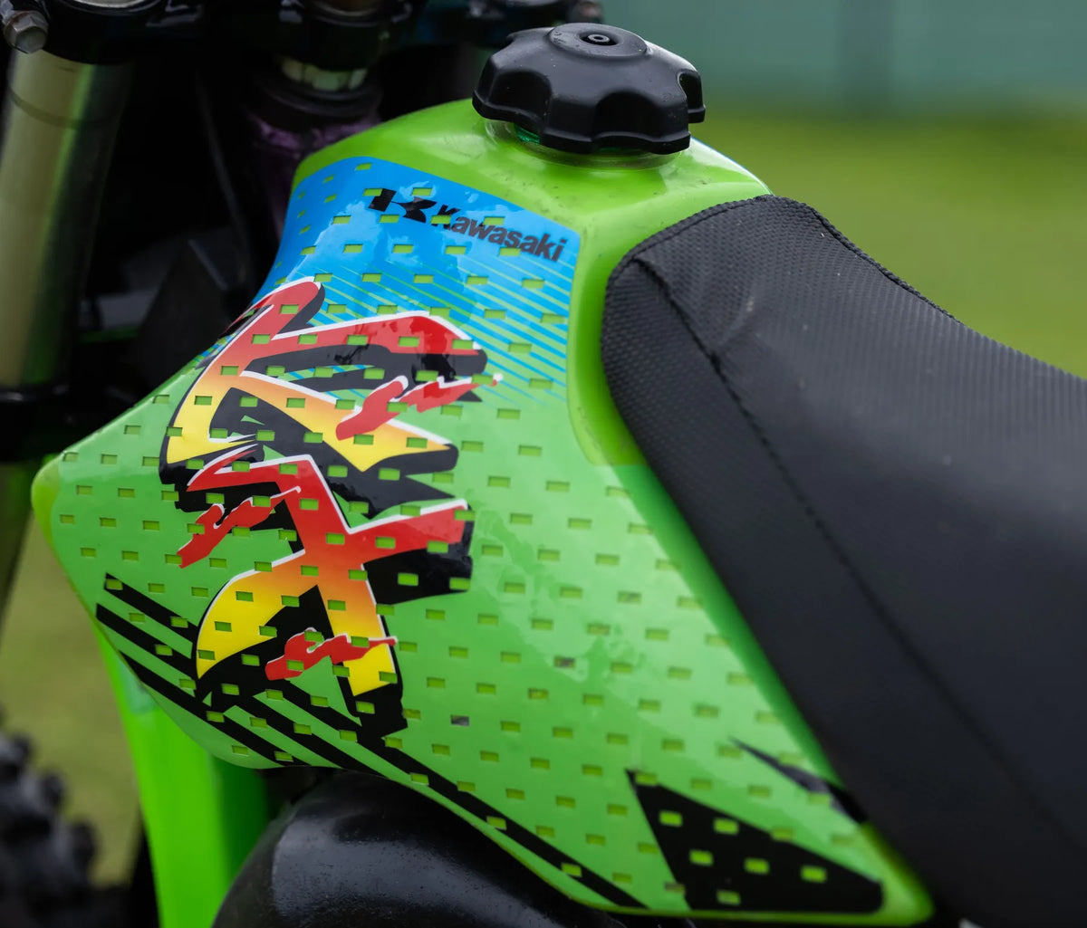 Macro close-up of the green KX tank and seat graphics
